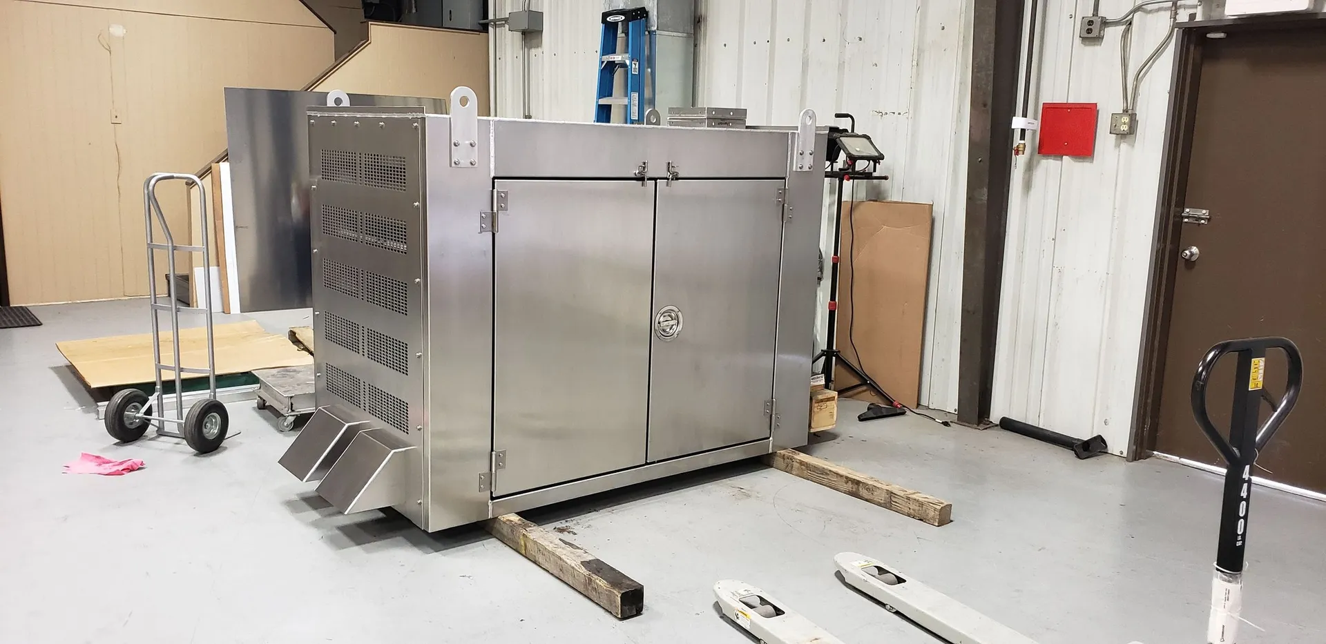 Industrial generator enclosure fabricated from stainless steel