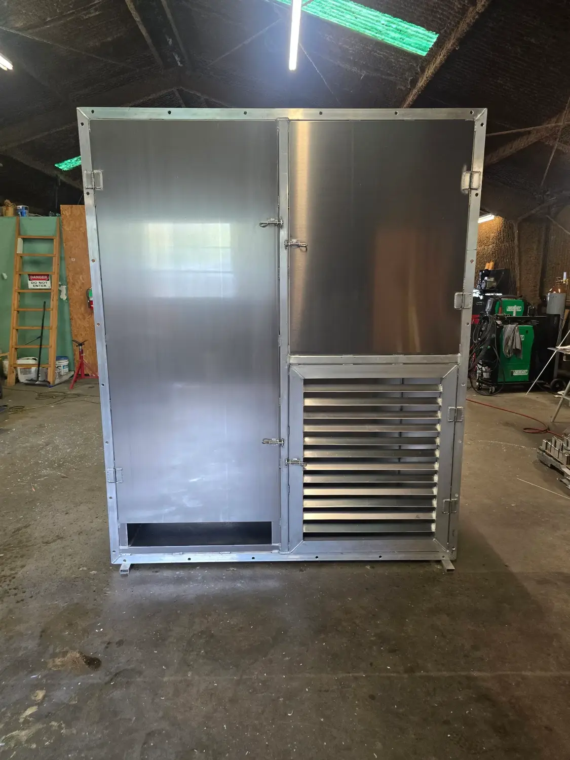 Custom vented aluminum equipment enclosure with fitted access doors